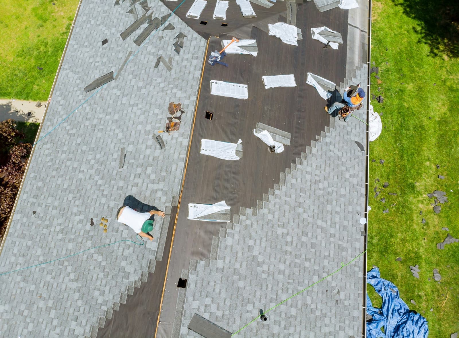 Roofer working on shingle roof